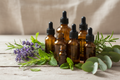 Essential oil bottles and herbs